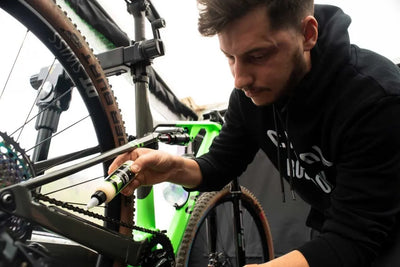 Applying the chain wax to a bike