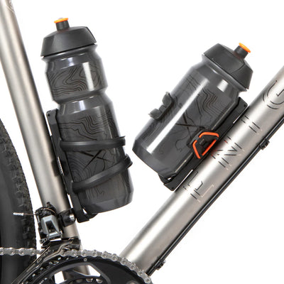 Bicycle with two grey water bottles in the Restrap side release bottle cage to the frame on a white background