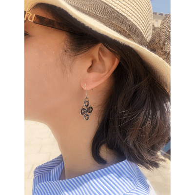 Diamond bake chain earrings being worn